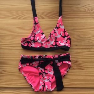 A cute anchor bikini that is pink,black and white
